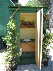 Inside there is a $5 toilet seat on a bench that conceals a bucket.