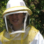 Miranda surrounded by very angry bees.  No stings penetrated her bee suit, but on a humid day in the mid-90's that suit sure was hot.