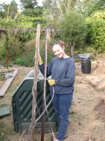 Miranda holding the completed and filled bunyip.  Work the air bubble out of the hose by lifting the bottom.